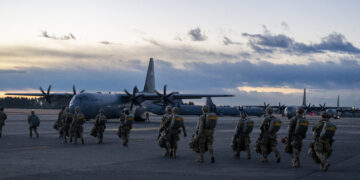 U.S. Army paratroopers prepare to board a C-130J Super Hercules at Yokota Air Base, Japan, for airdrop insertion during exercise North Wind 26.