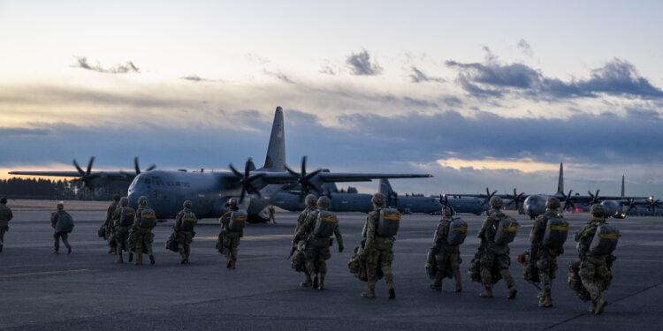 U.S. Army paratroopers prepare to board a C-130J Super Hercules at Yokota Air Base, Japan, for airdrop insertion during exercise North Wind 26.