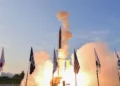 Arrow missile defense system interceptor launch with Israel and US flags.