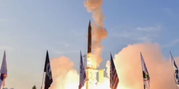 Arrow missile defense system interceptor launch with Israel and US flags.