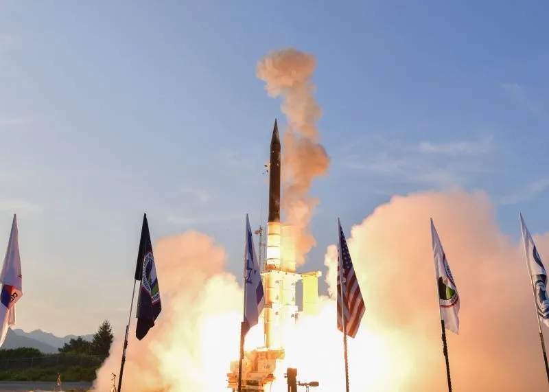 Arrow missile defense system interceptor launch with Israel and US flags.