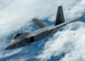 F-22 Raptor stealth fighter jet flying through clouds, representing Mobix Labs' expanded role in the defense program.