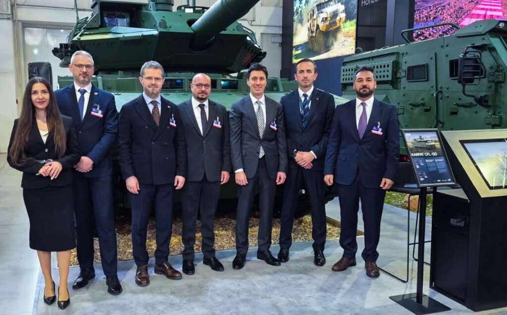 Management teams from FNSS and CSG in front of the CFL-120 Karpat medium tank at IDEB 2026.