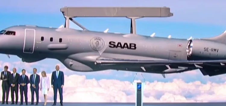 NATO Secretary General Mark Rutte and Saab officials pose in front of the alliance's new generation early warning aircraft, GlobalEye.