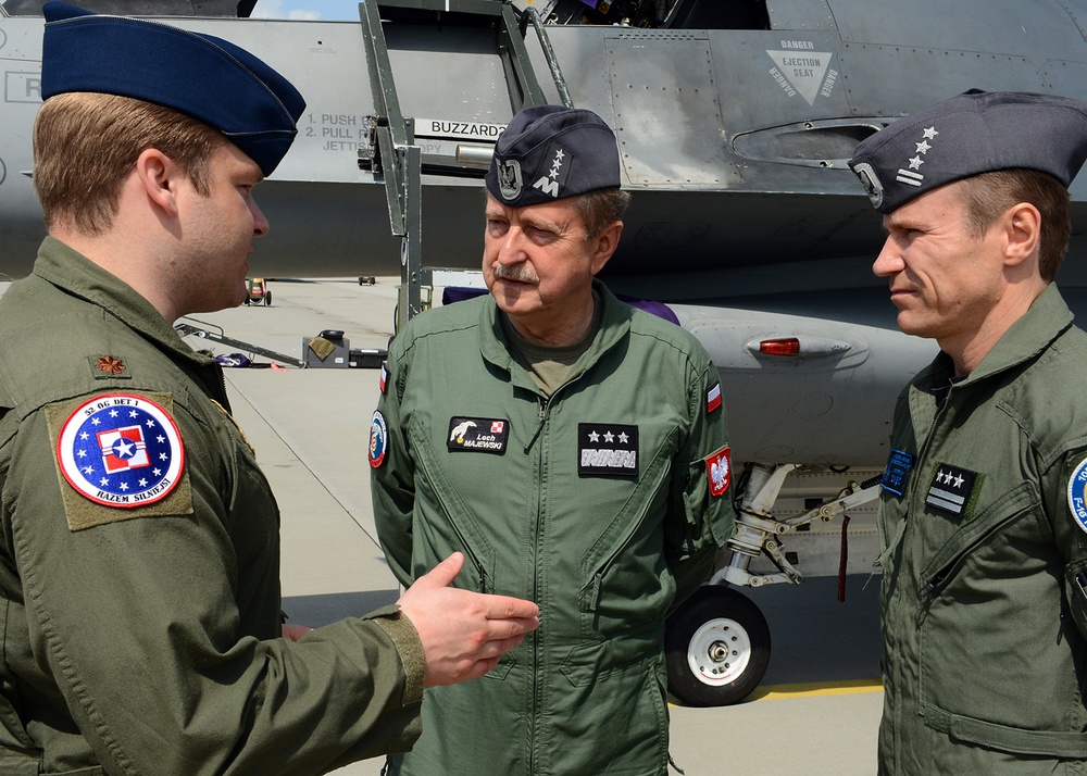 Poland NATO defence: Polish and allied air force personnel standing in front of a fighter jet, highlighting military aviation cooperation and readiness.