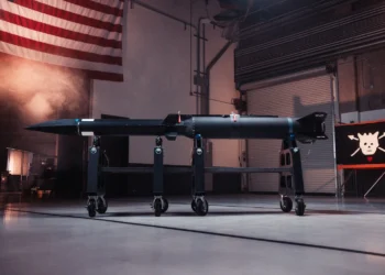 Castelion's Blackbeard hypersonic missile displayed on a transport cradle in a hangar, with a U.S. flag in the background