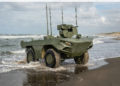 FNSS İ-ZAHA unmanned amphibious vehicle emerging from the sea onto a sandy beach during testing