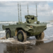 FNSS İ-ZAHA unmanned amphibious vehicle emerging from the sea onto a sandy beach during testing