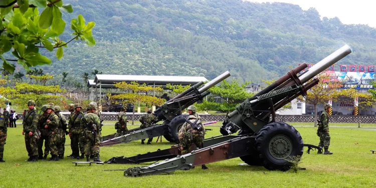 Taiwan Army soldiers pictured with towed howitzers during a military exercise