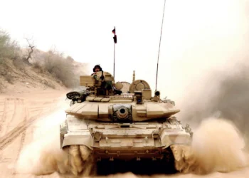 A T-90 tank advancing through the desert