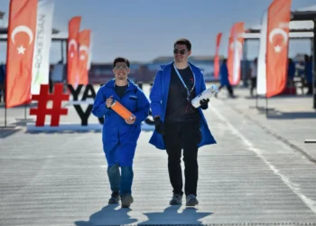 Two finalist team members carry rocket components at the TEKNOFEST Rocket Competition